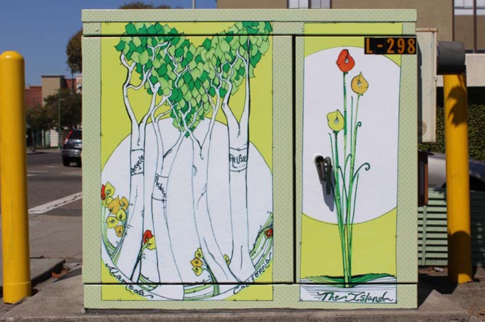 A power box painted with trees and flowers on it.