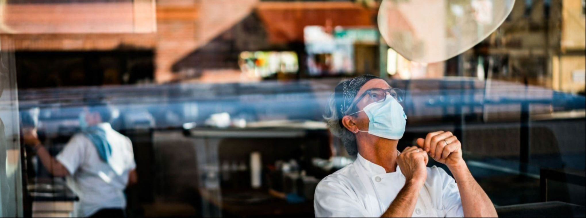 Man throwing pizza door in air in a restaurant